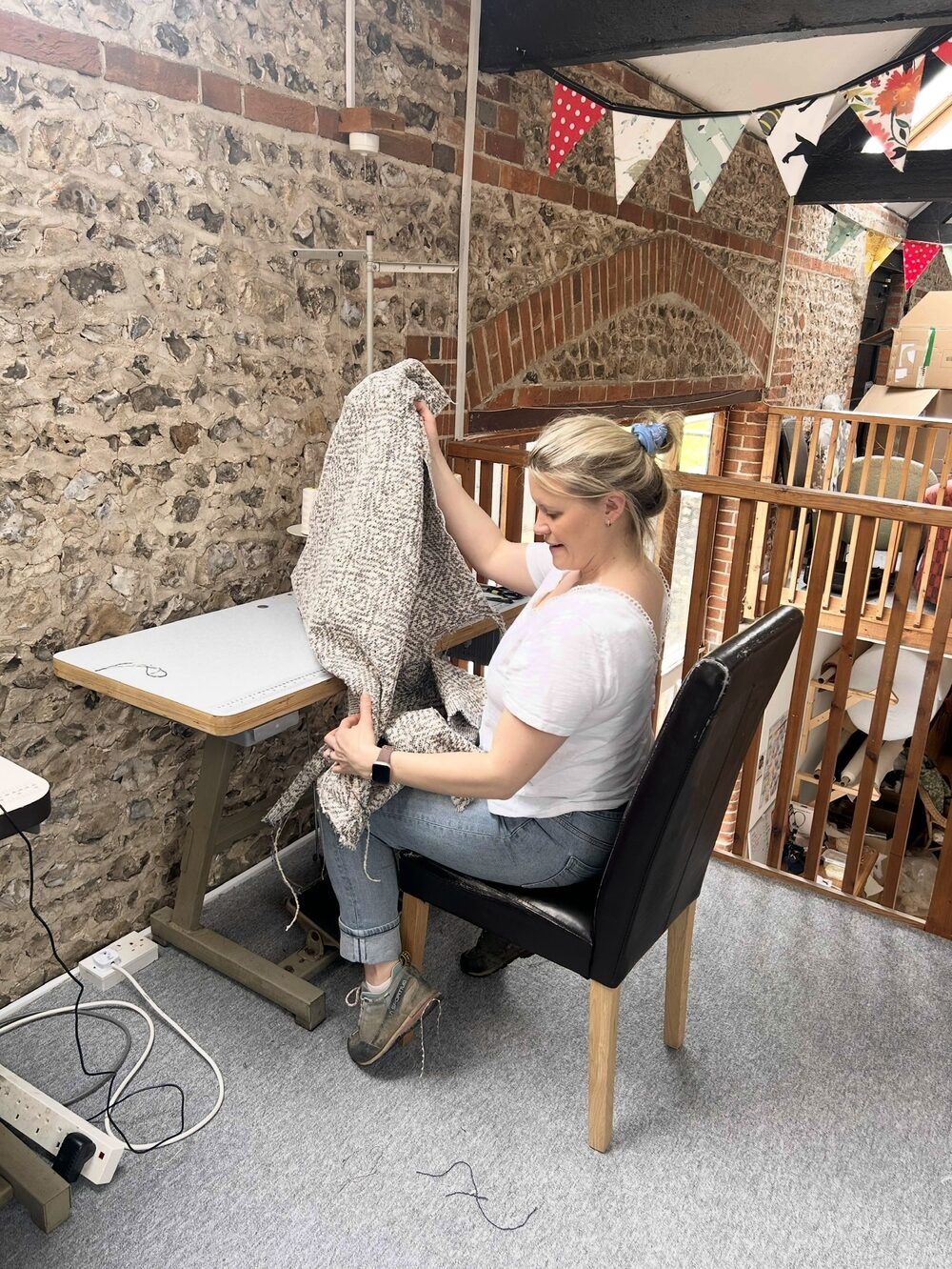 Dawn at her industrial sewing machine working with a large piece of fabric