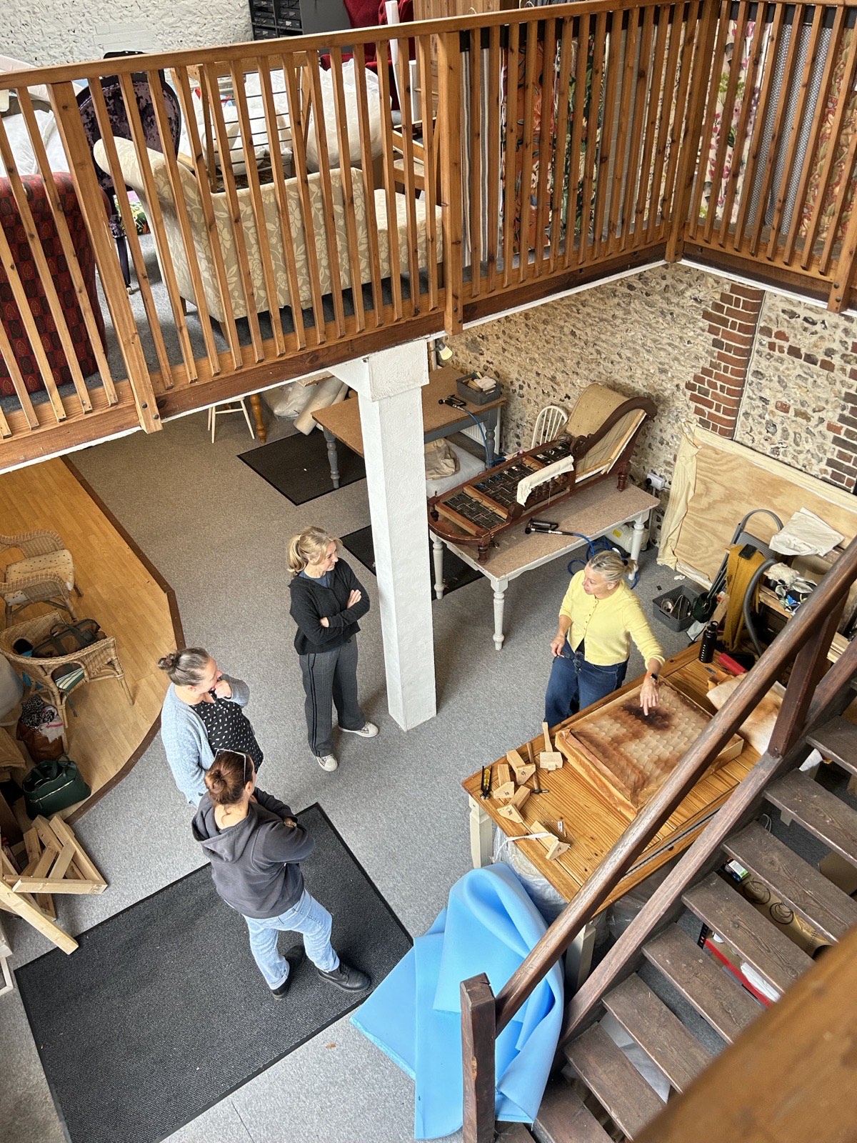 A group of students in conversation with Dawn in the studio by the stairs